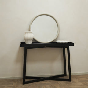 Concrete Round Wall Mirror standing on a console table