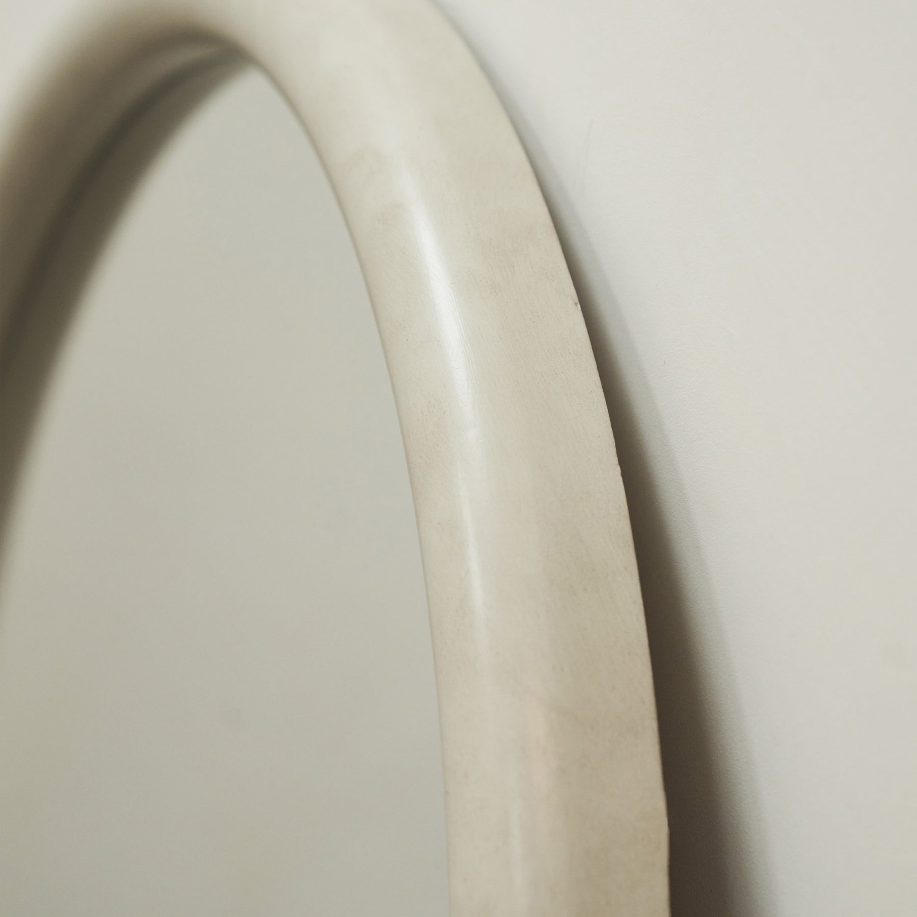 Closeup of our Large Concrete Round Wall Mirror curved frame