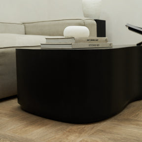 Minimal Black Large Irregular Shaped Coffee Table adorned with books