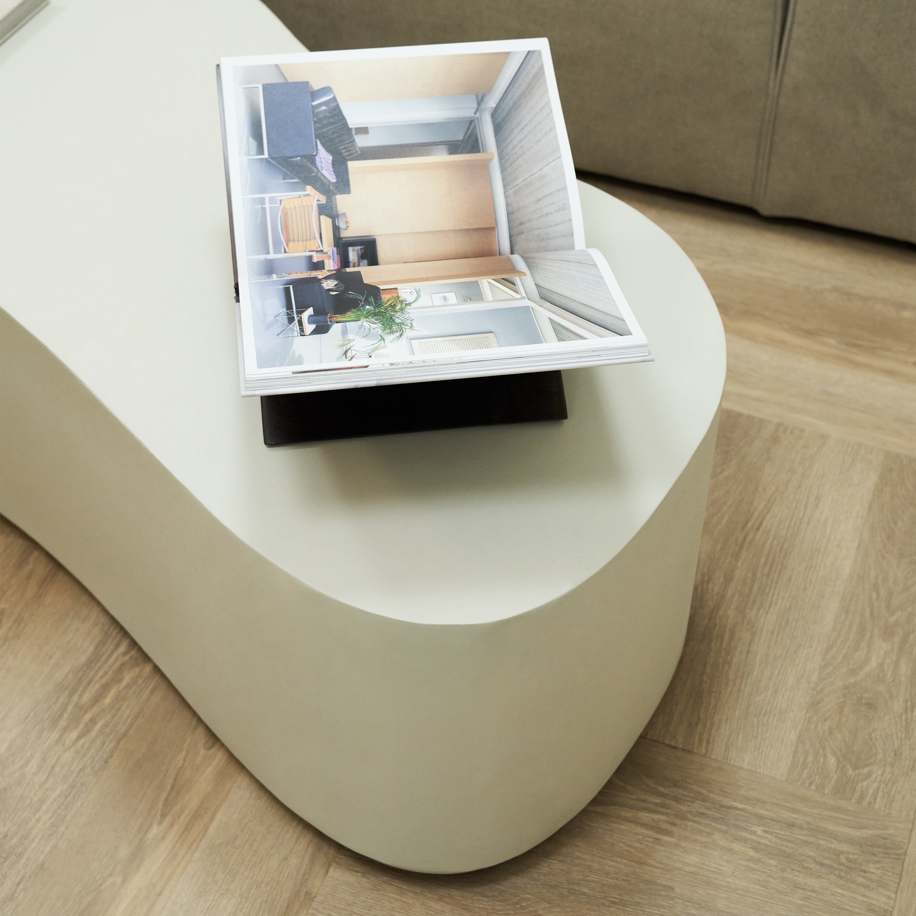 Minimal Concrete Large Irregular Shaped Coffee Table decorated with book