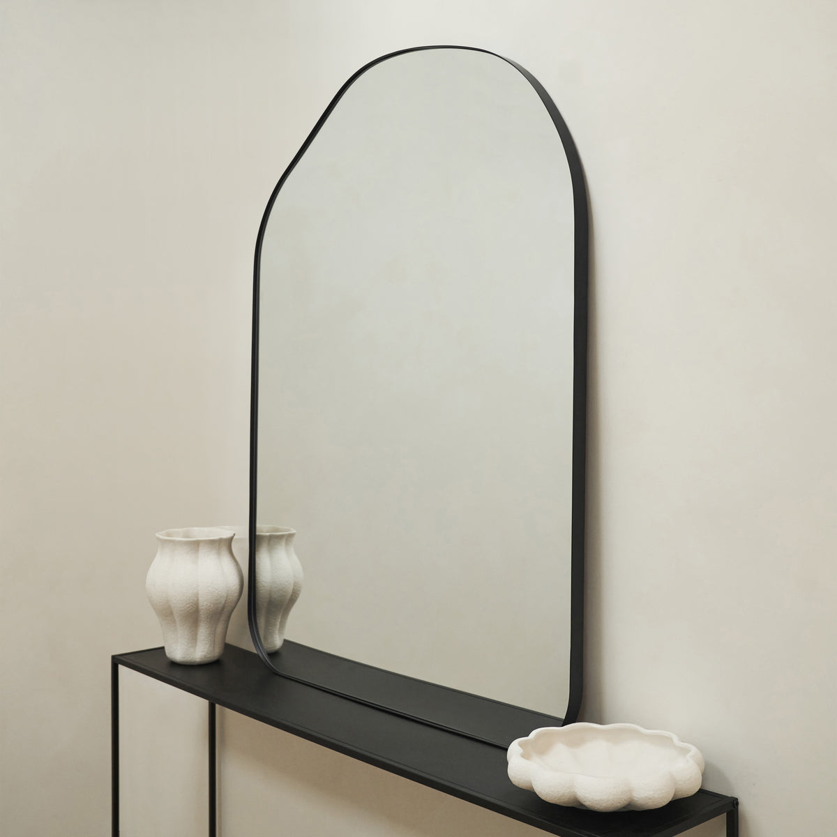 Large Irregular Arched Black Metal Wall Mirror on console table