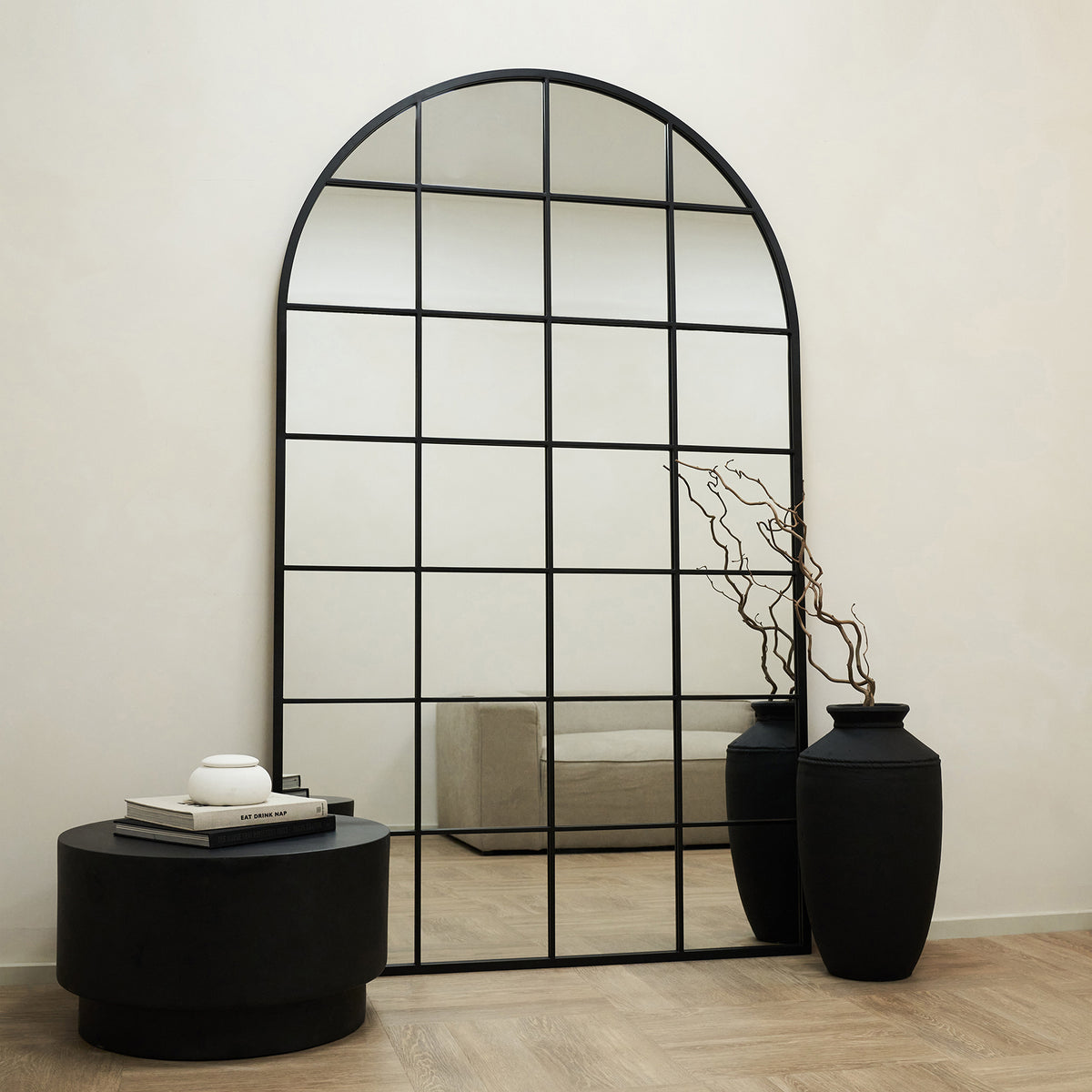 Full Length Extra Large Black Arched Metal Window Mirror leaning against wall