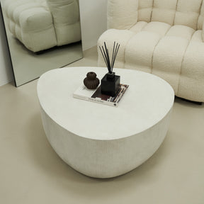 Minimal Concrete Irregular Shaped Coffee Table Large in a typical setting, beside mirror and sofa