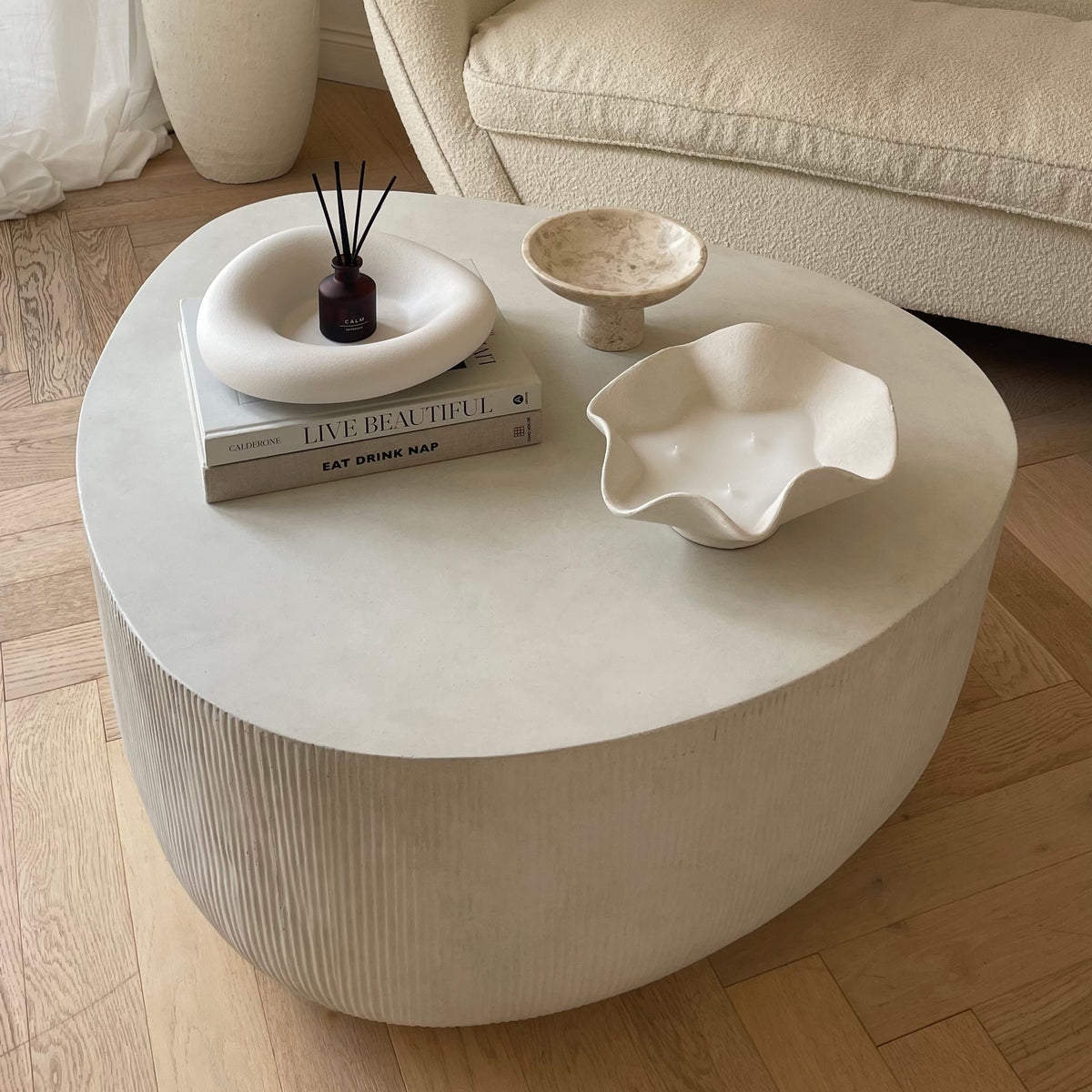 Minimal Concrete Irregular Shaped Coffee Table Large in a typical setting, candles unlit