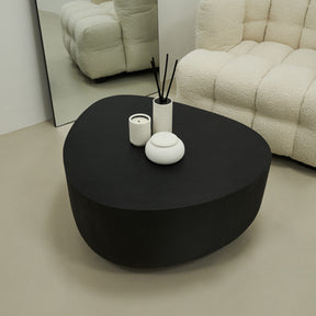 Minimal Onyx Irregular Shaped Coffee Table Large in a typical setting, beside sofa and mirror