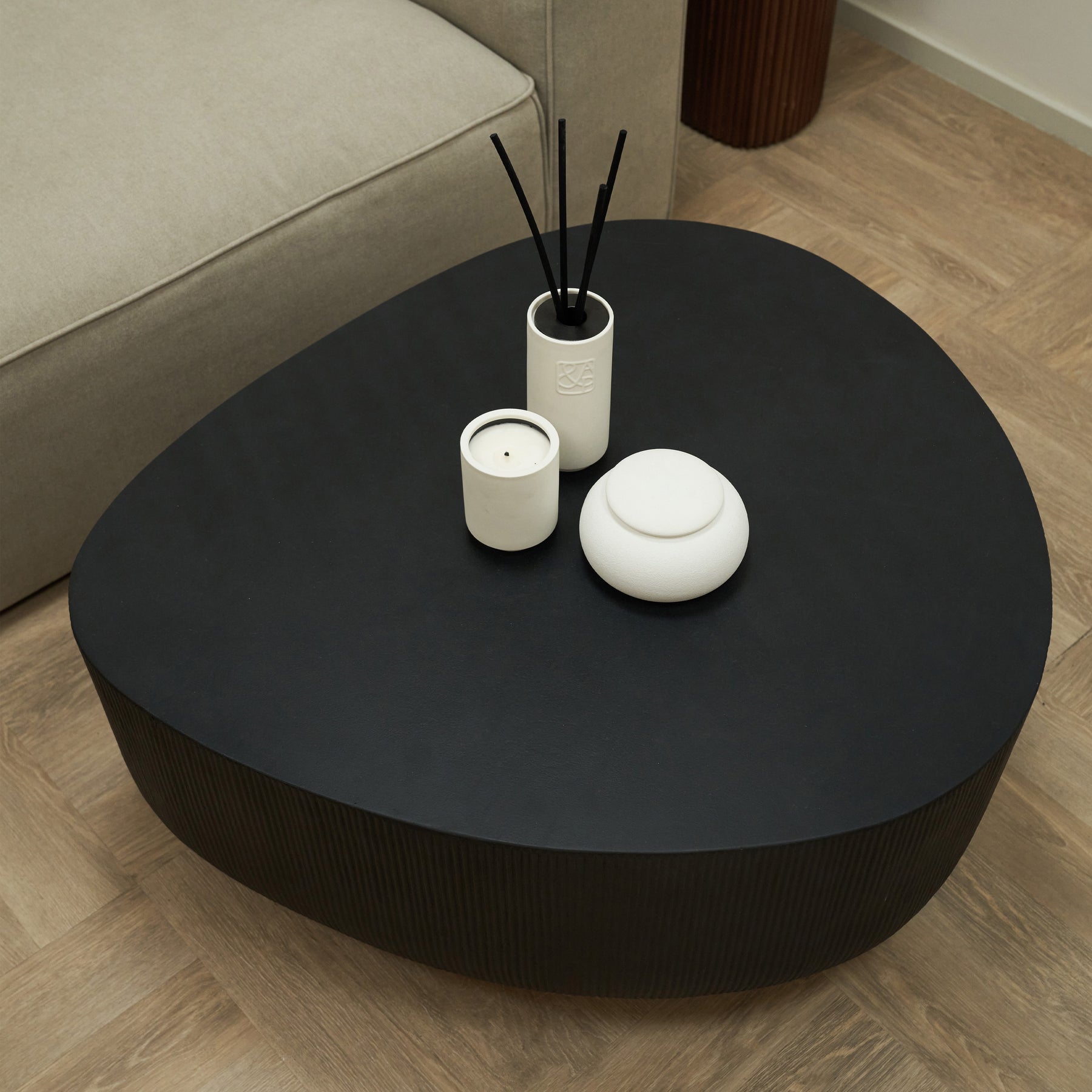Minimal Onyx Irregular Shaped Coffee Table Large adorned with candles, pots, and incense