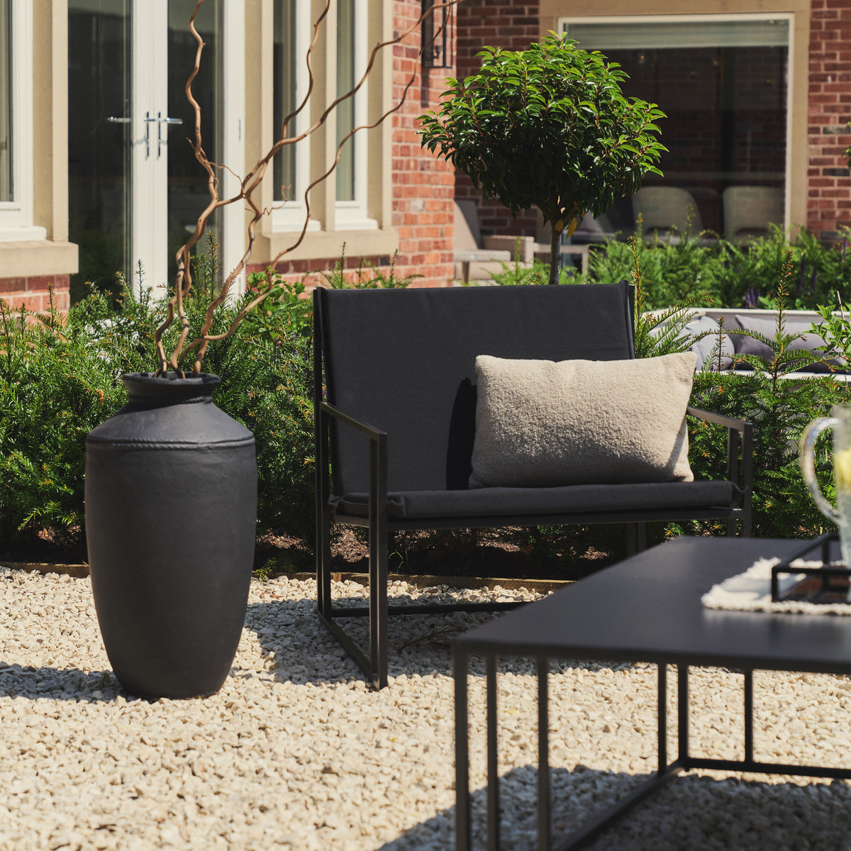 Rectangular Black Modern Garden chair beside toledo vase