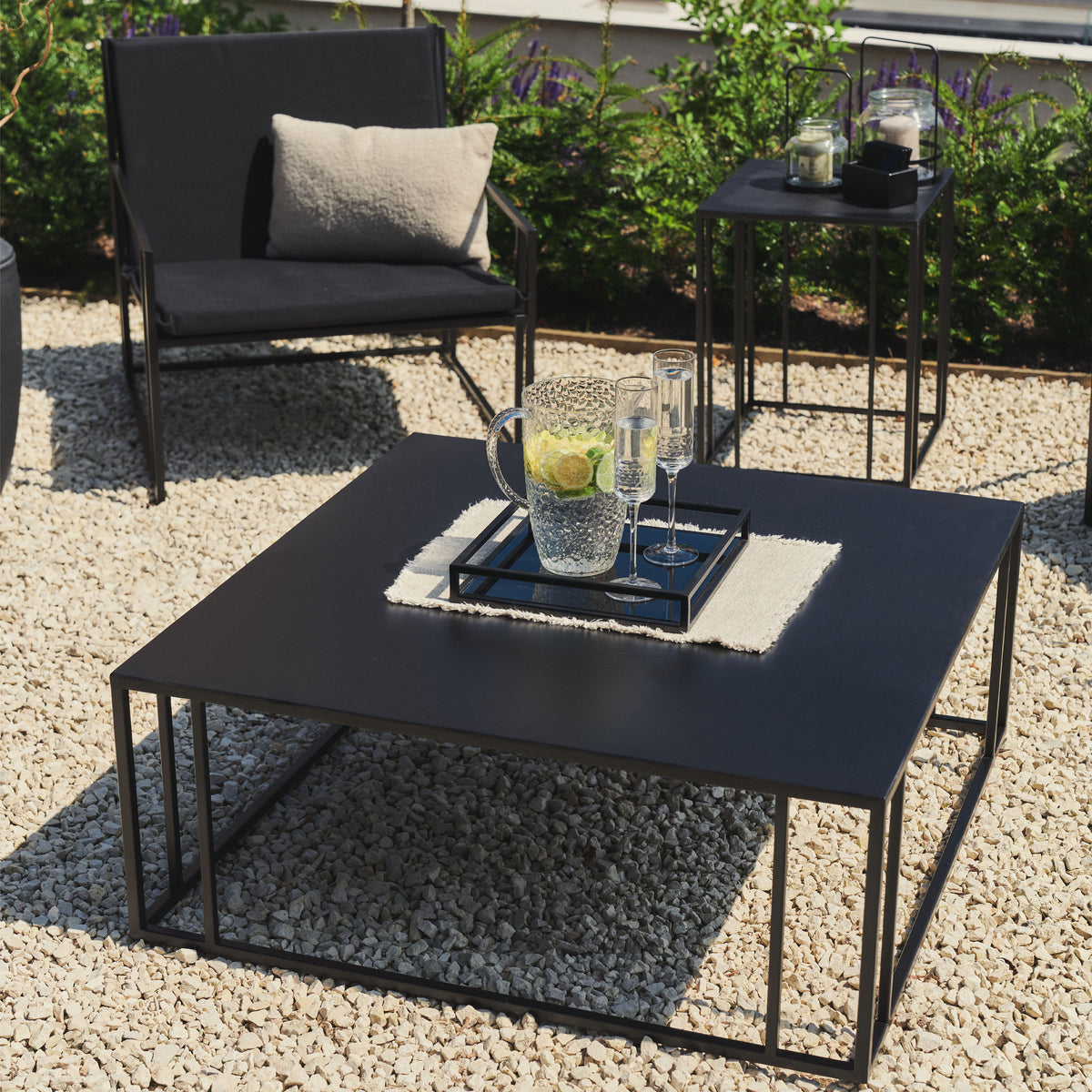 Rectangular Black Modern Garden Coffee Table with jug holding citrus drink