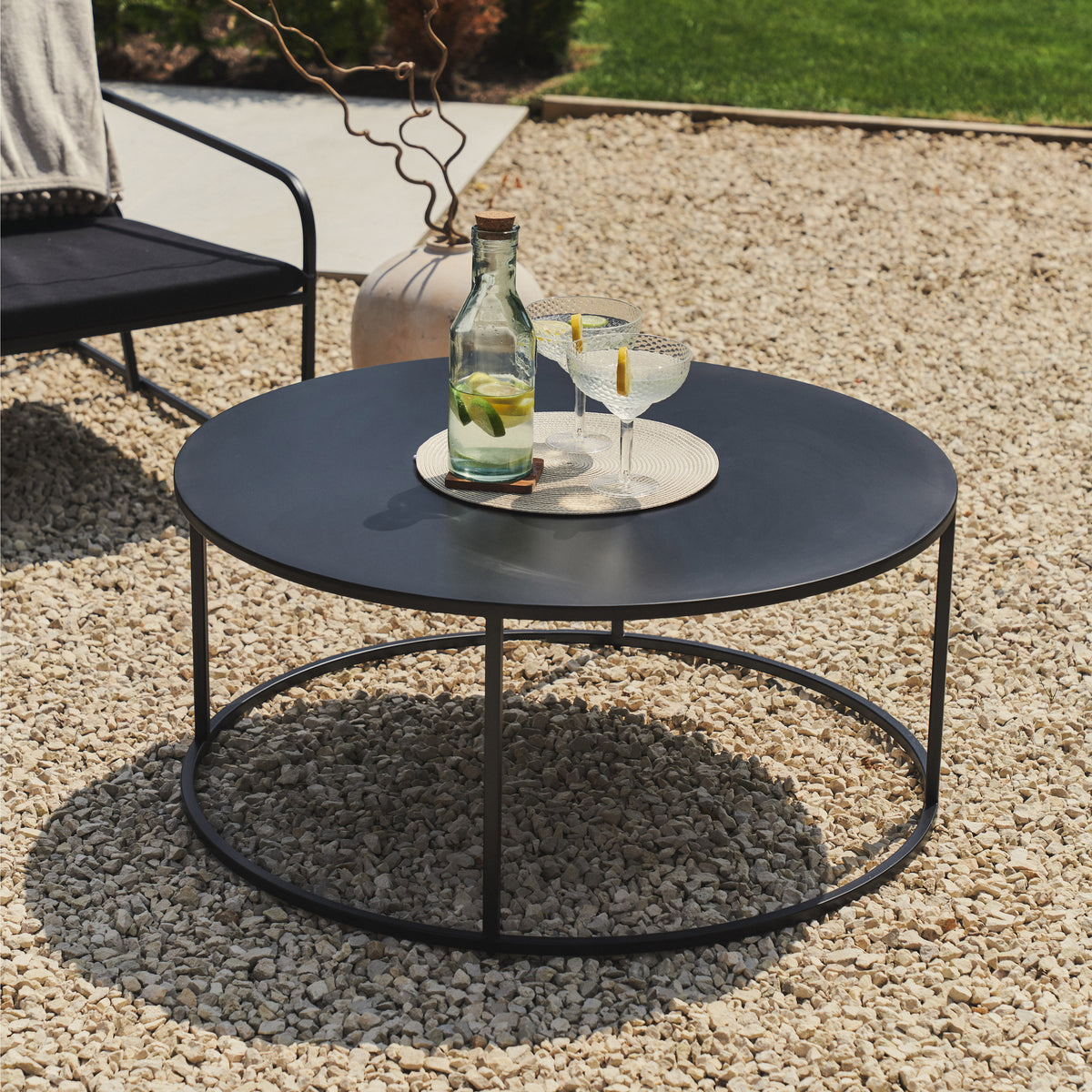 Black Modern Rounded Garden Coffee Table with citrus drink