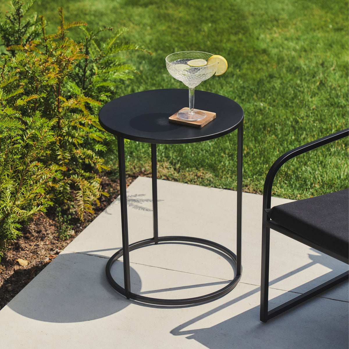 Black Modern Rounded Garden Side Table with citrus drink