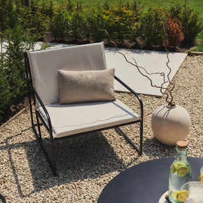 Sand Modern Rounded Garden Chair beside beige vase