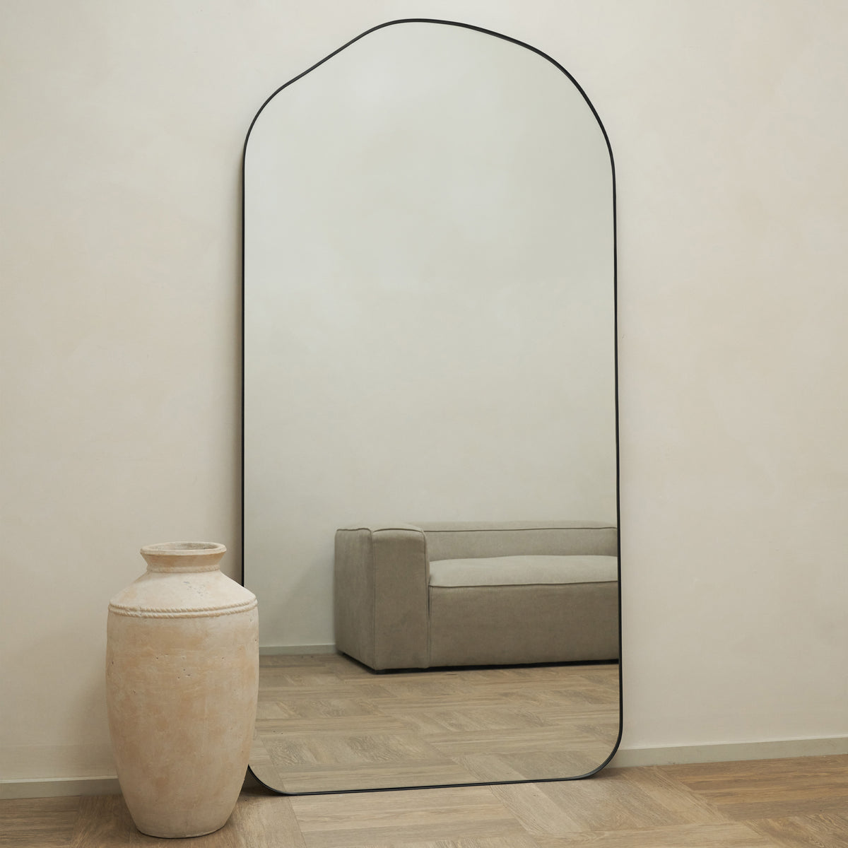 Full length irregular minimalist mirrorLarge Full Length Irregular Arched Black Metal Mirror leaning against wall