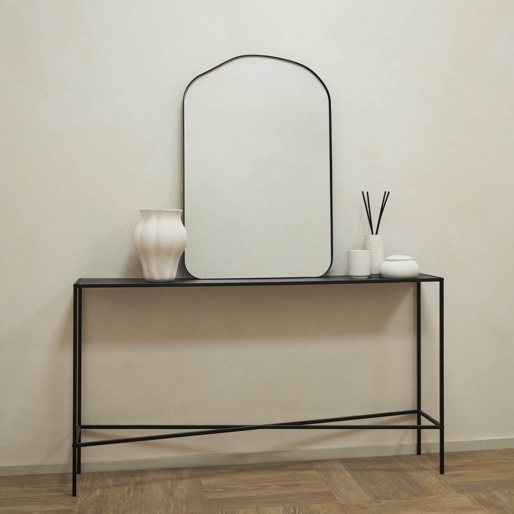 Alternate shot of Irregular Arched Black Metal Wall Mirror on console table