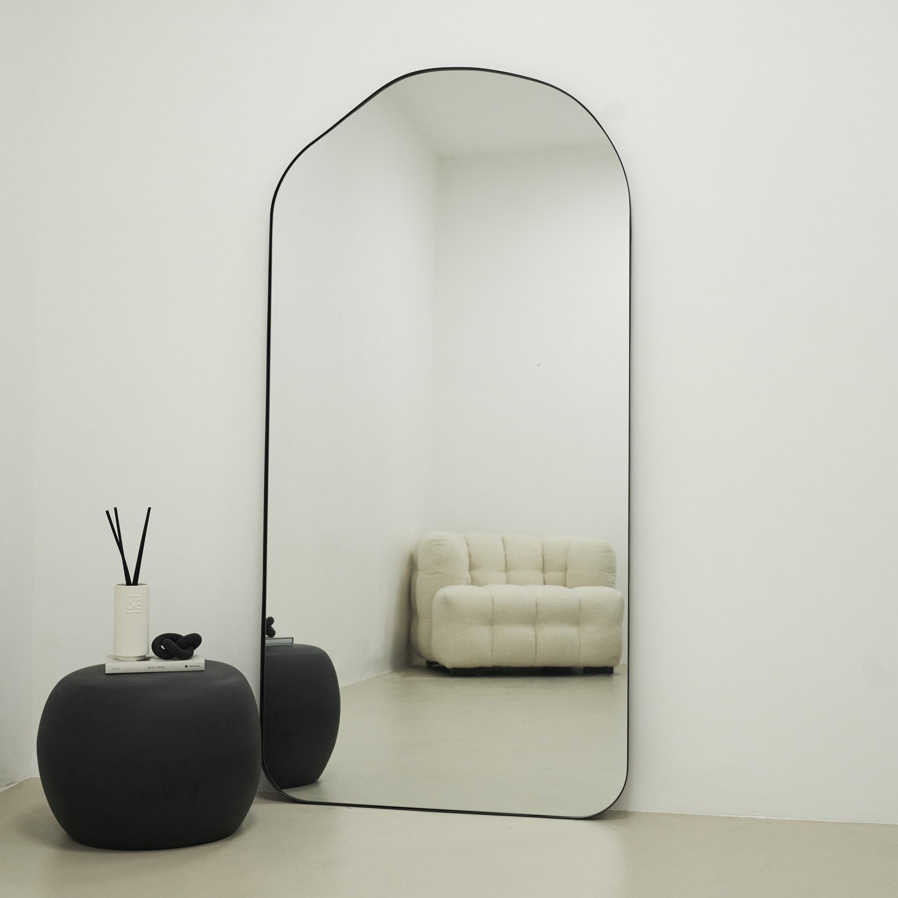 Large Full Length Irregular Arched Black Metal Mirror beside zola table