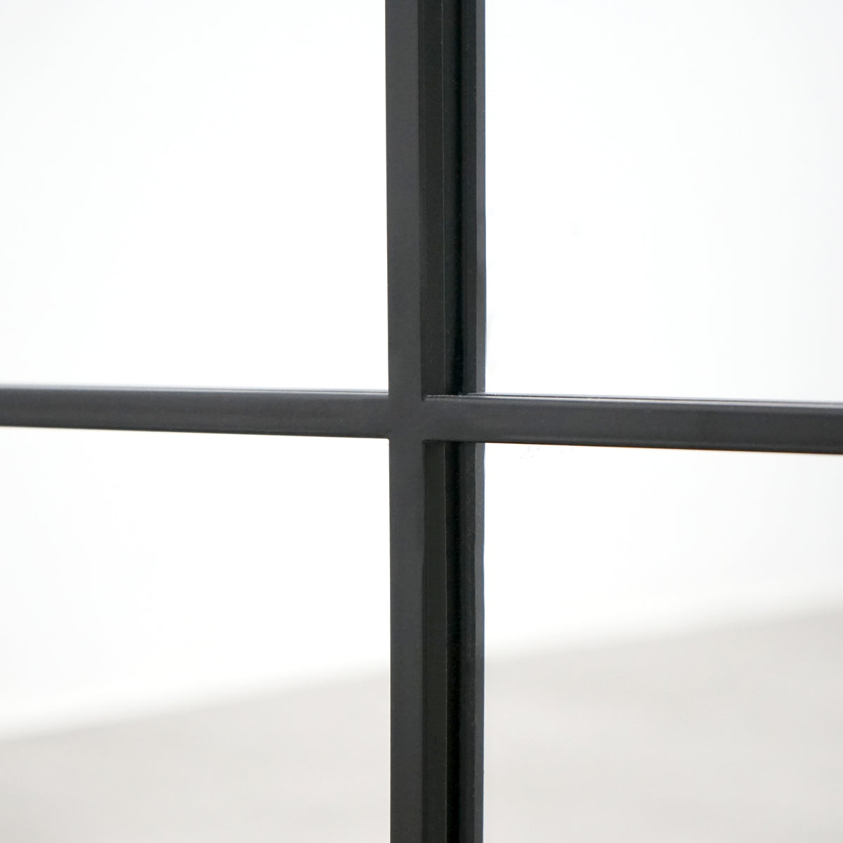 Closeup of Full length XL black industrial metal window mirror